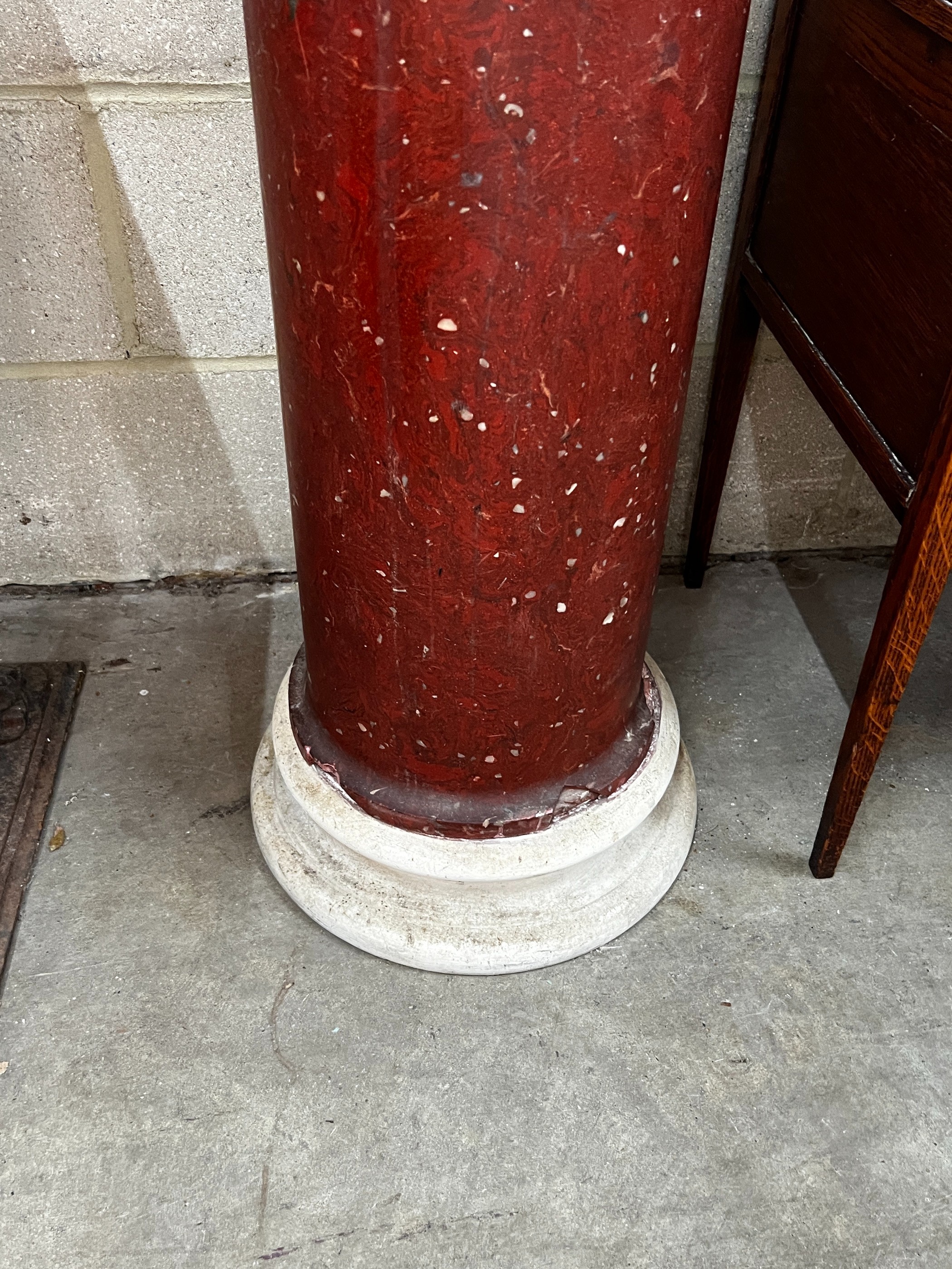 A faux porphyry column with circular marble top, height 104cm